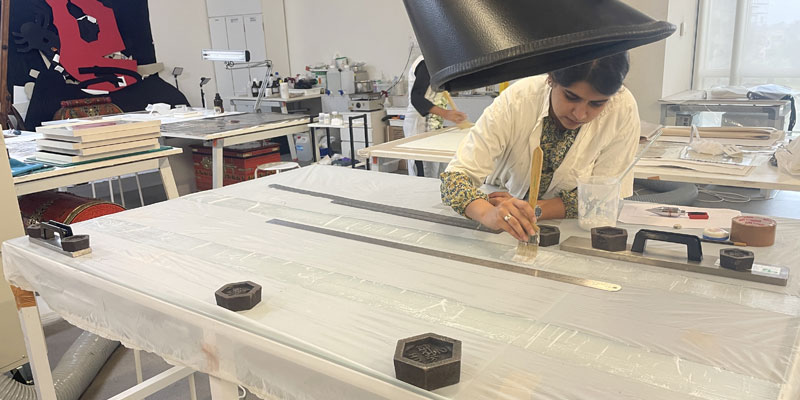 Conservator Keerat Garcha working on Arunima Choudhury’s eco-prints, getting them ready for display