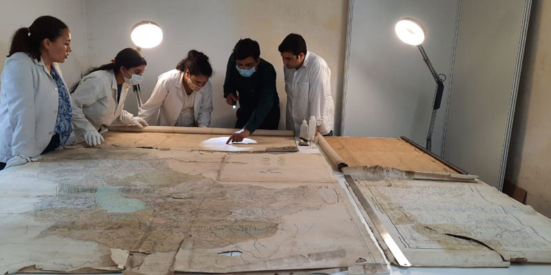 The HIMSHACO conservation team working on the historical maps received by the Kumaon Commissioner’s office