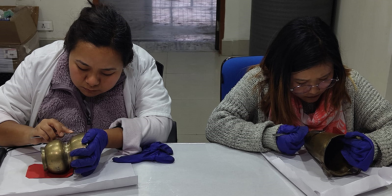 Participants undertaking cleaning of metal objects.